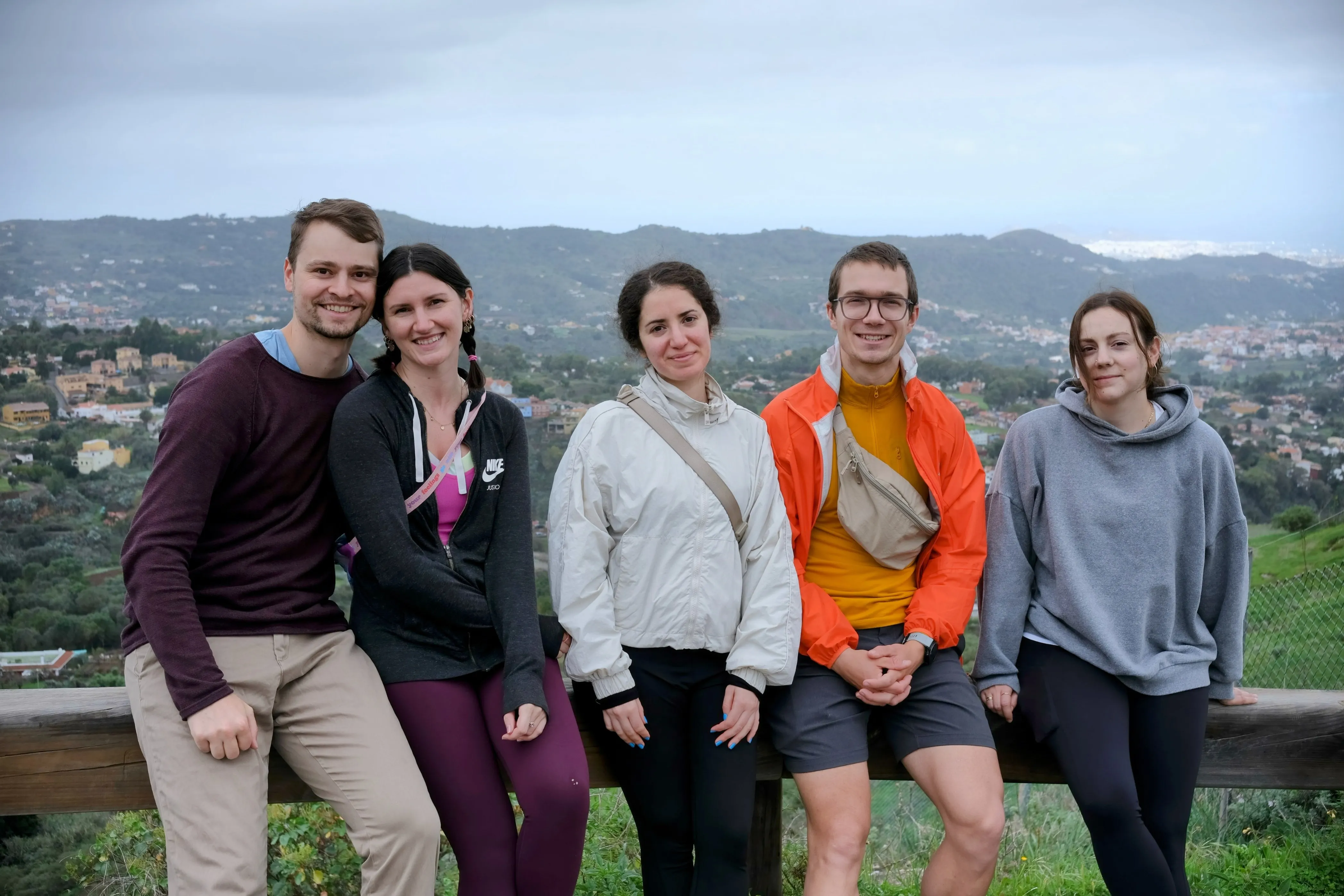 Connor, Jillian, Iris, Mat, and Ena pose for a group photo in front of the hilly Gran Canarian landscape