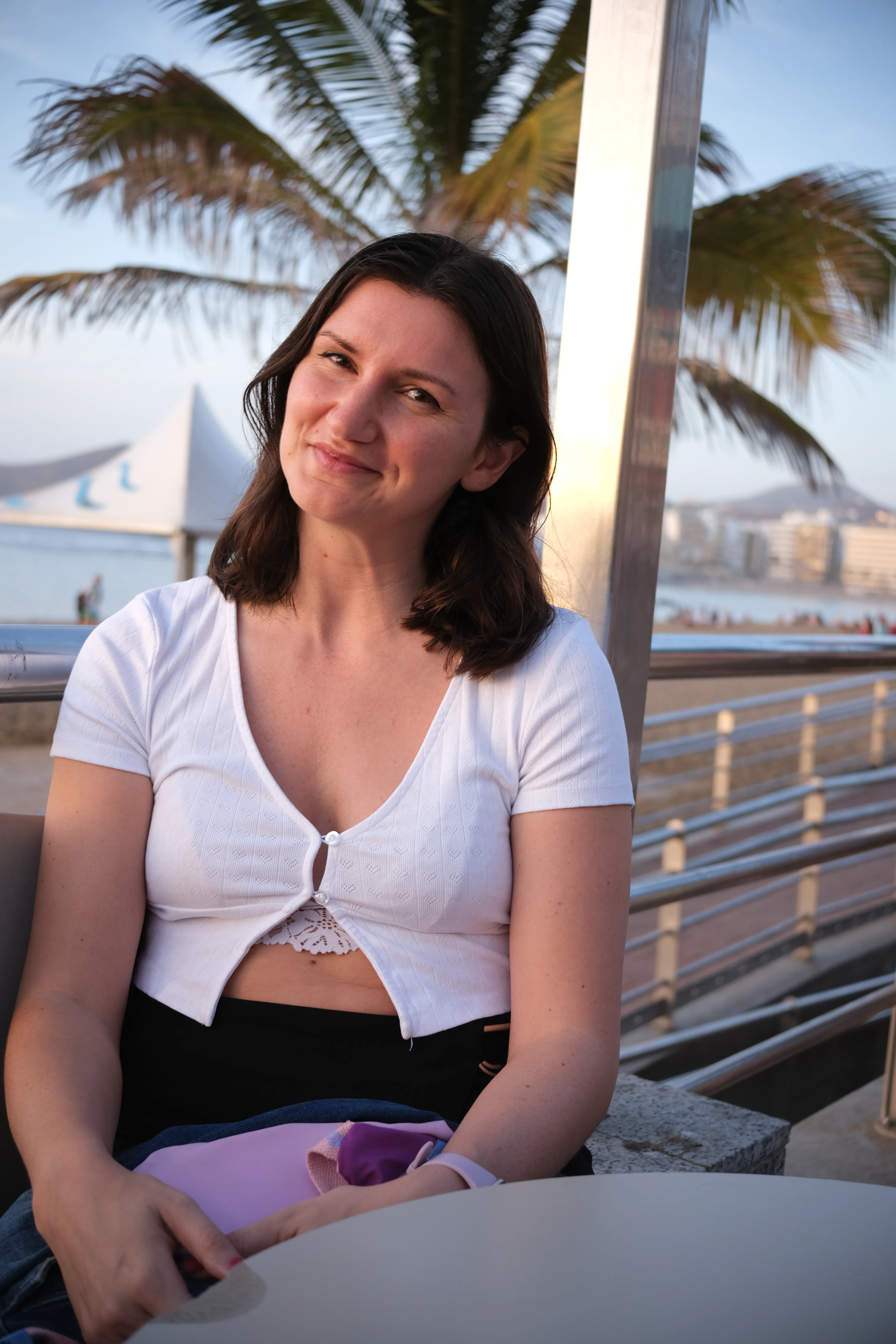 Portrait of Jillian at the board walk during golden hour with a palm tree in the background.